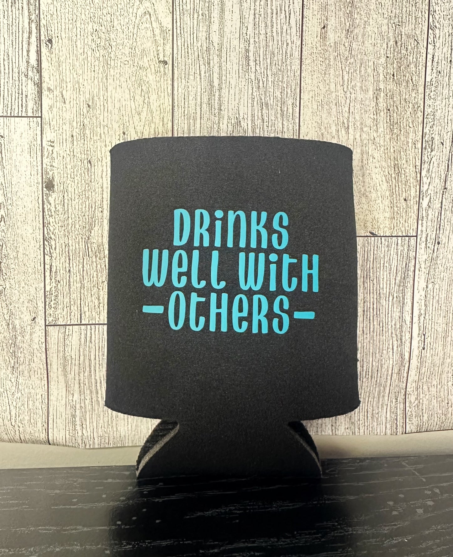 Drinks well with others koozie